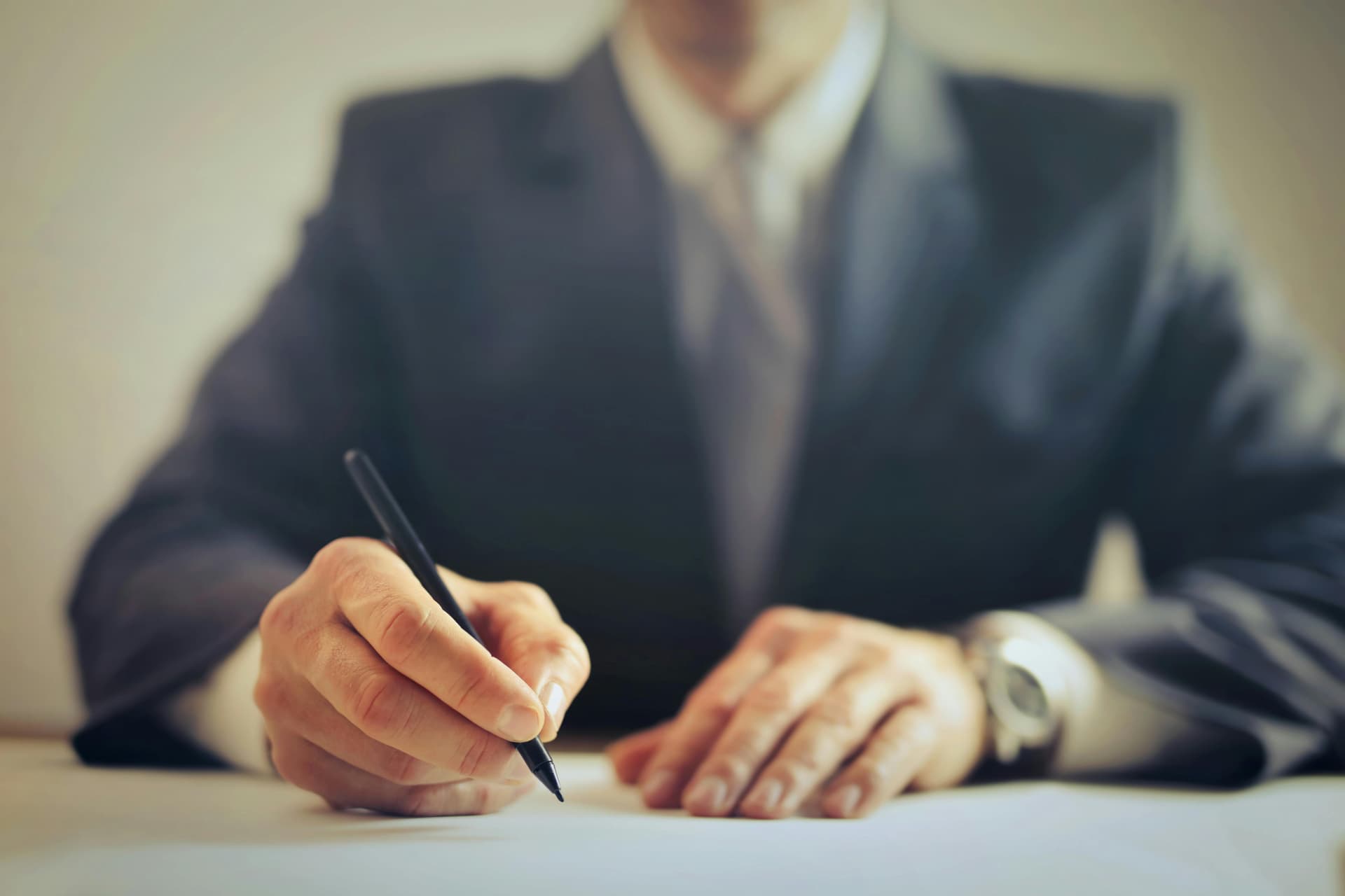 Businessperson signing a contract in an office
